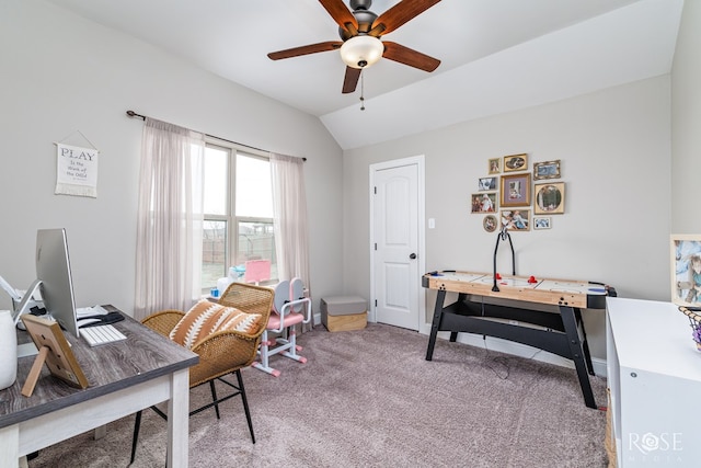 office space featuring vaulted ceiling, light carpet, and ceiling fan