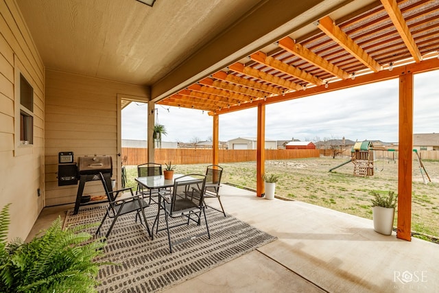 view of patio / terrace featuring fence, outdoor dining space, a pergola, and a playground