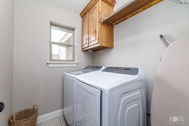 laundry area with tile patterned floors, cabinet space, baseboards, and separate washer and dryer