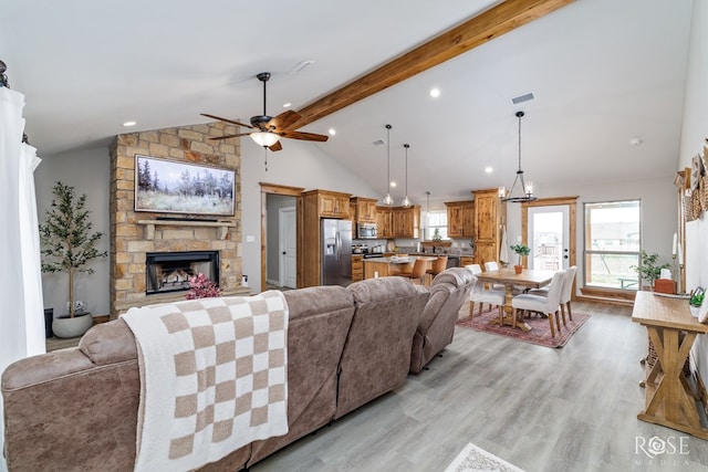 living room with a ceiling fan, beam ceiling, recessed lighting, a fireplace, and light wood-type flooring