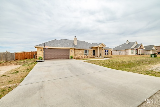 ranch-style home featuring fence, driveway, an attached garage, a front lawn, and stone siding