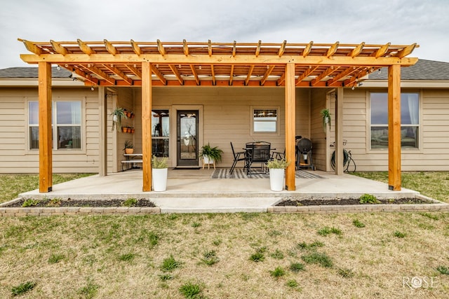 back of property featuring a yard, a patio area, and a pergola