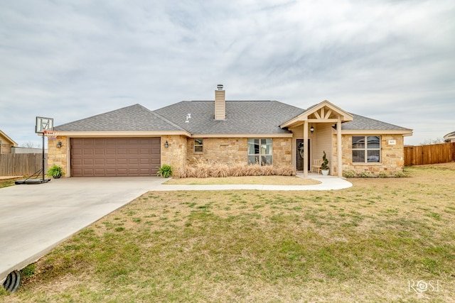 ranch-style house featuring fence, concrete driveway, a front yard, a garage, and stone siding