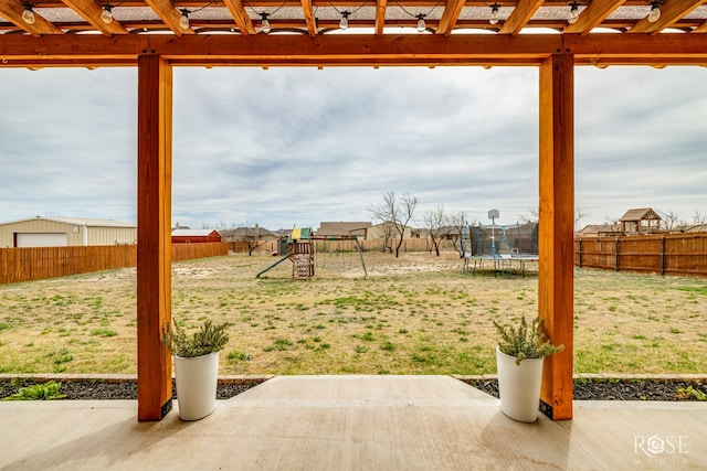 view of yard featuring a playground, a trampoline, a patio area, and a fenced backyard