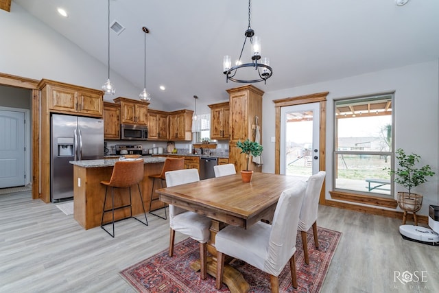 dining area featuring visible vents, high vaulted ceiling, recessed lighting, light wood-style floors, and a notable chandelier