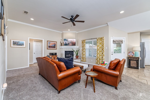 carpeted living room with crown molding and ceiling fan