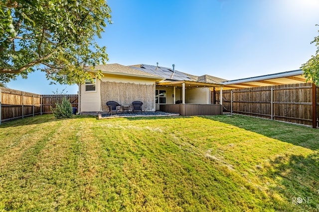 rear view of house featuring a yard