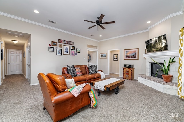 carpeted living room with crown molding, ceiling fan, and a fireplace