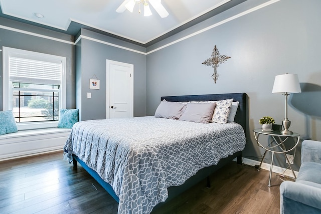 bedroom featuring crown molding, dark hardwood / wood-style floors, and ceiling fan