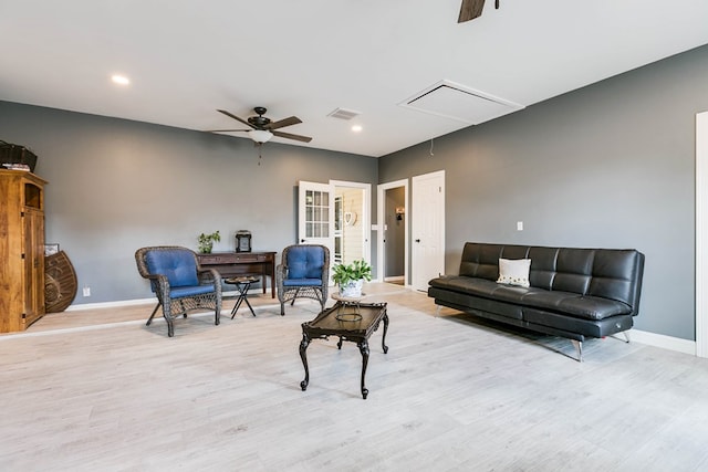 living room featuring ceiling fan and light hardwood / wood-style floors