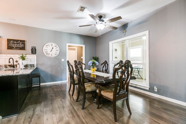 dining room with dark hardwood / wood-style floors, sink, and ceiling fan