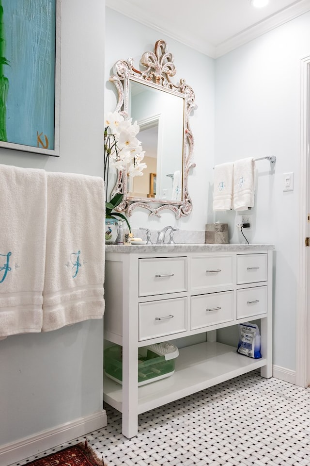 bathroom with ornamental molding and vanity