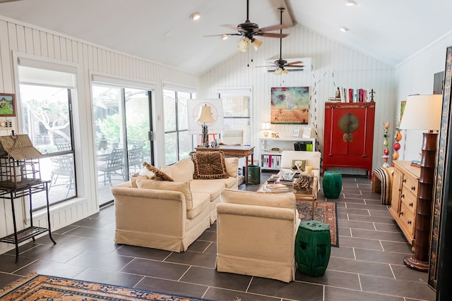 living room with vaulted ceiling, plenty of natural light, and wooden walls