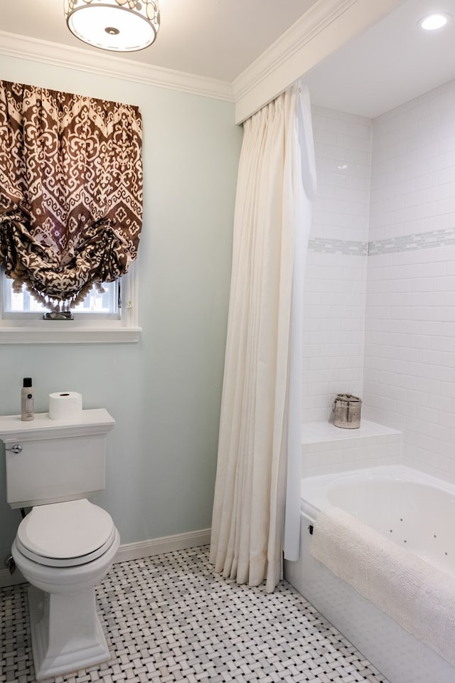 bathroom featuring ornamental molding, toilet, and a bathing tub