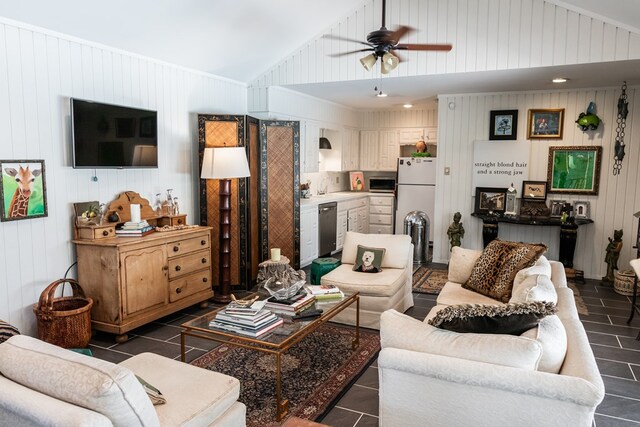 tiled living room with vaulted ceiling, sink, ceiling fan, and wooden walls