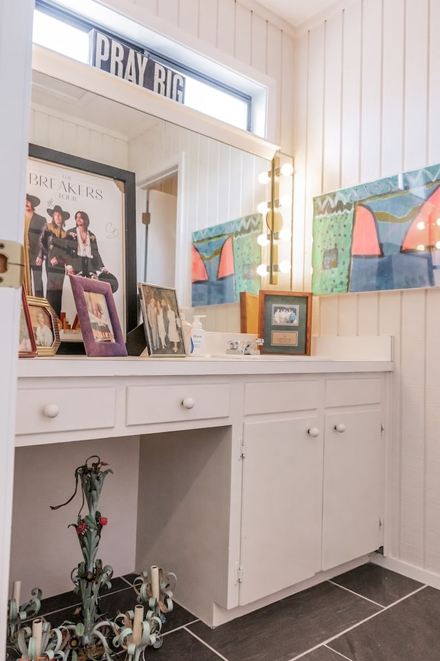 bathroom featuring wooden walls and tile patterned flooring