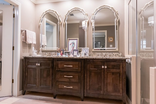 bathroom featuring ornamental molding and vanity