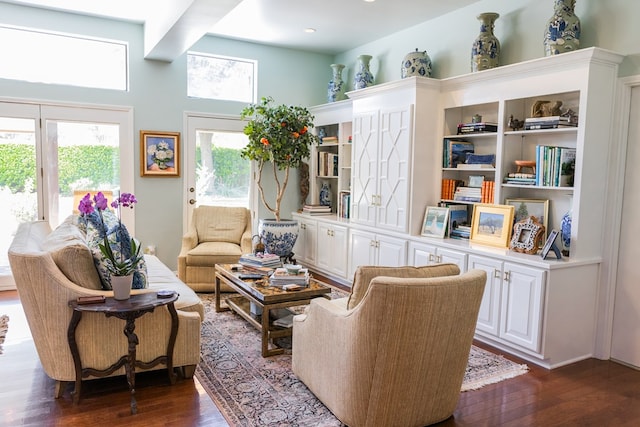 sitting room featuring a towering ceiling and dark hardwood / wood-style floors