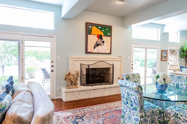 dining area with hardwood / wood-style flooring and a high end fireplace