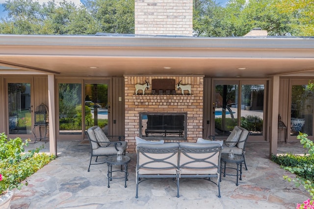 view of patio featuring an outdoor brick fireplace