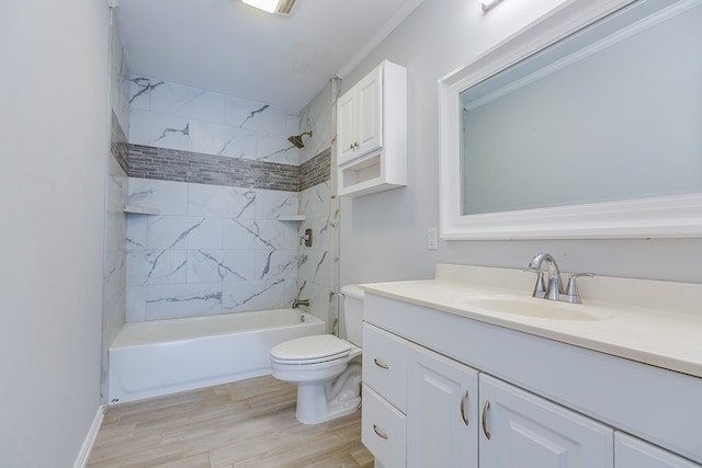 full bathroom featuring toilet, crown molding, tiled shower / bath, wood-type flooring, and vanity