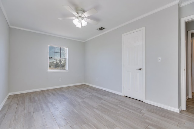 spare room featuring ceiling fan, ornamental molding, and light wood-type flooring