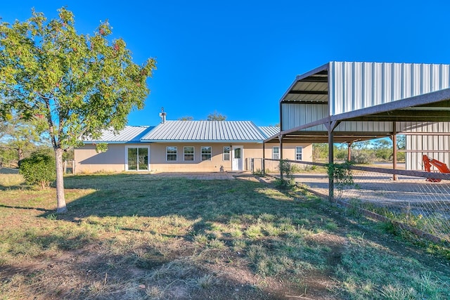 rear view of house with a yard