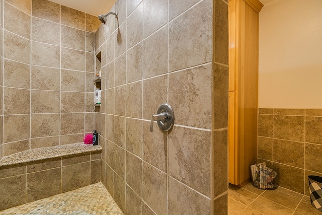 bathroom with tile walls and tiled shower