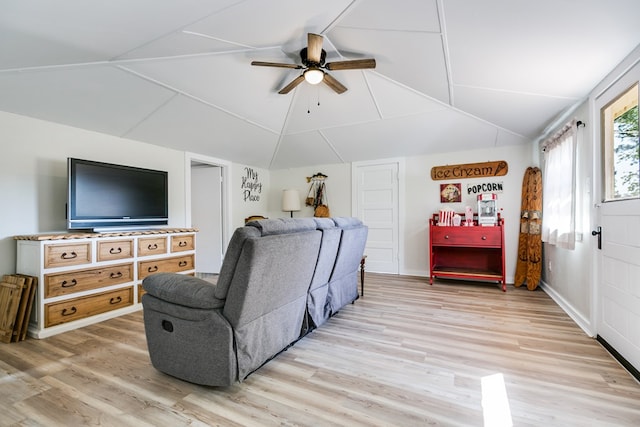 living room with light wood-style floors, ceiling fan, and vaulted ceiling