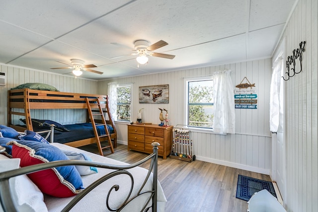 bedroom with baseboards, ceiling fan, and wood finished floors