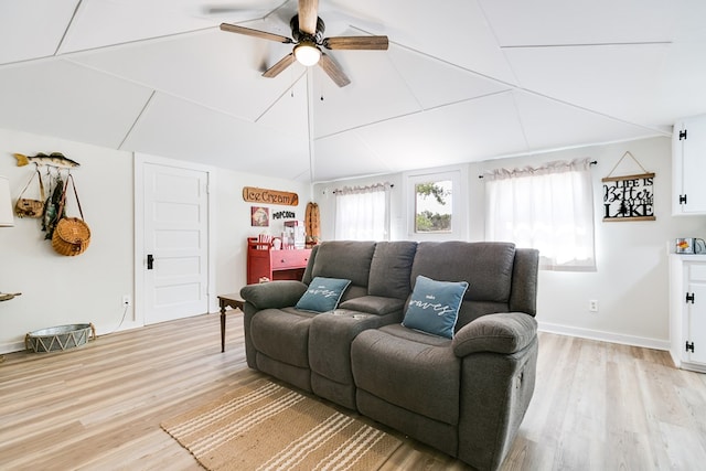 living area featuring light wood finished floors, ceiling fan, and lofted ceiling