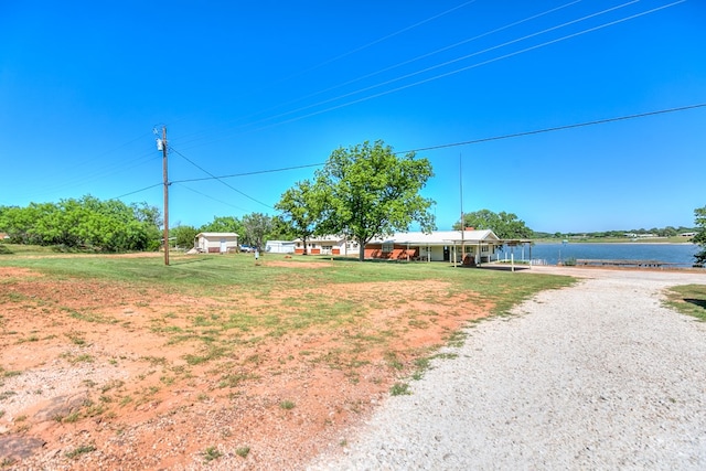 view of front of property featuring a water view and driveway