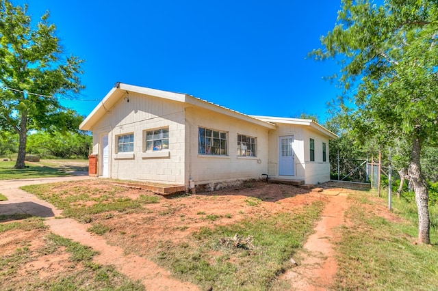 view of side of property with concrete block siding