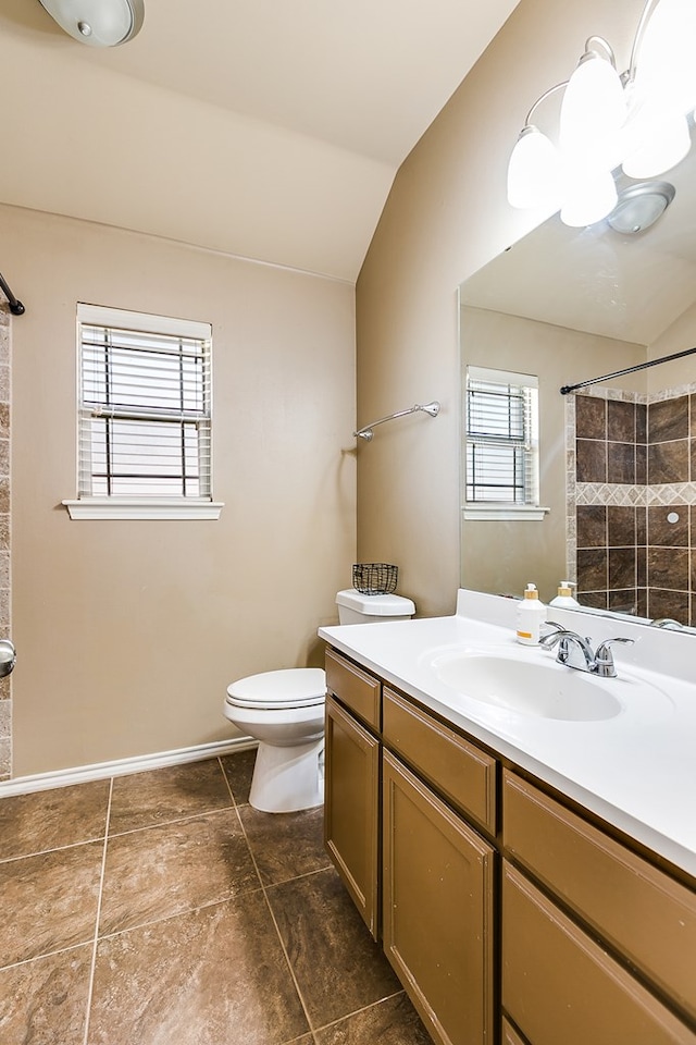 bathroom with walk in shower, lofted ceiling, toilet, and vanity