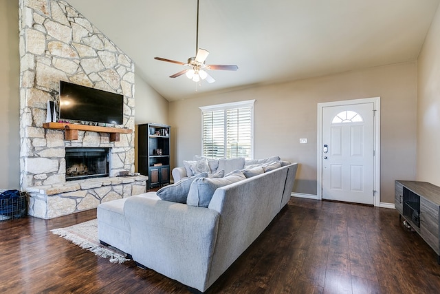 living room featuring vaulted ceiling, dark wood-type flooring, ceiling fan, and a fireplace