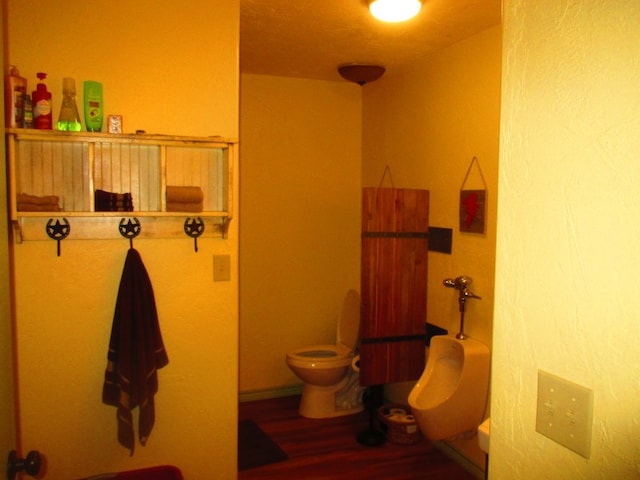 bathroom featuring hardwood / wood-style flooring and toilet