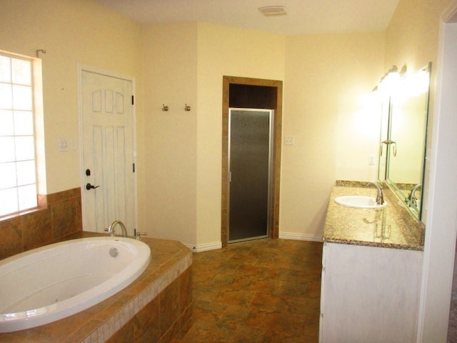 bathroom featuring vanity and shower with separate bathtub