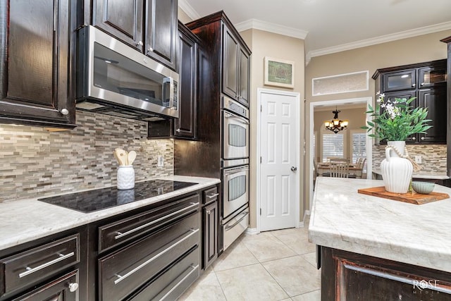 kitchen featuring dark brown cabinetry, light tile patterned floors, crown molding, and appliances with stainless steel finishes