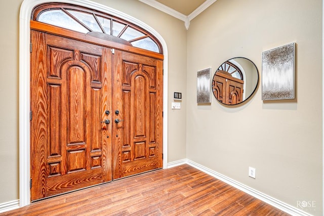 entryway featuring crown molding and light hardwood / wood-style flooring