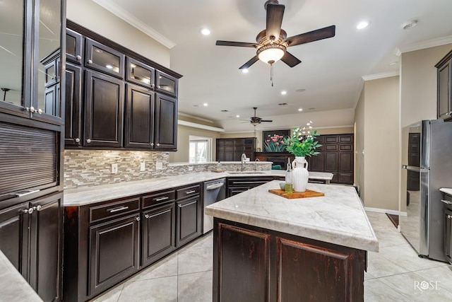 kitchen with a kitchen island, appliances with stainless steel finishes, sink, kitchen peninsula, and crown molding