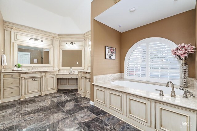 bathroom featuring vanity and a tub