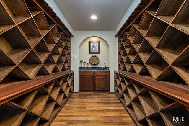 wine area with light hardwood / wood-style flooring