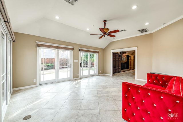 unfurnished room with crown molding, ceiling fan, vaulted ceiling, and light tile patterned floors