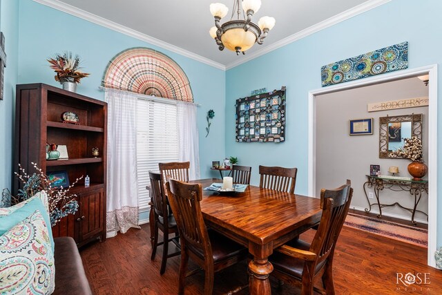 dining area featuring dark wood-type flooring, a chandelier, ornamental molding, and baseboards