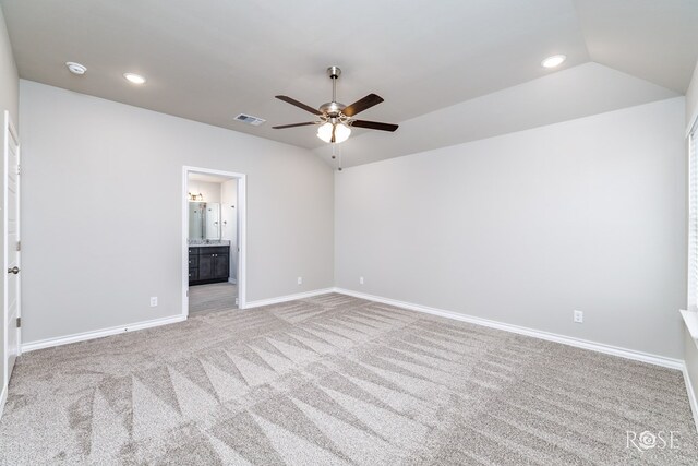 carpeted spare room featuring lofted ceiling, plenty of natural light, and ceiling fan