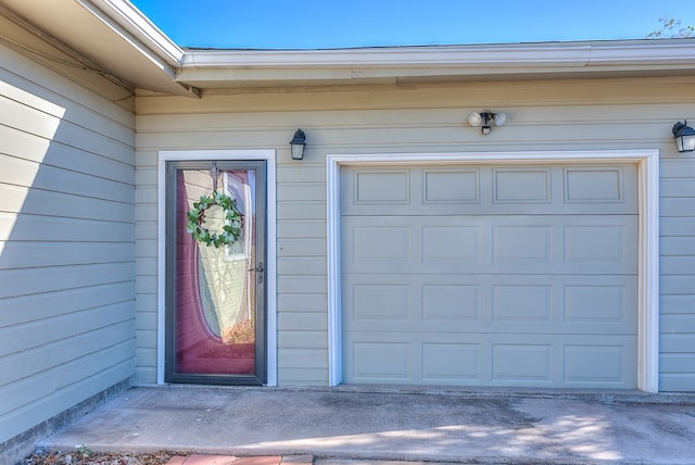 view of exterior entry with a garage