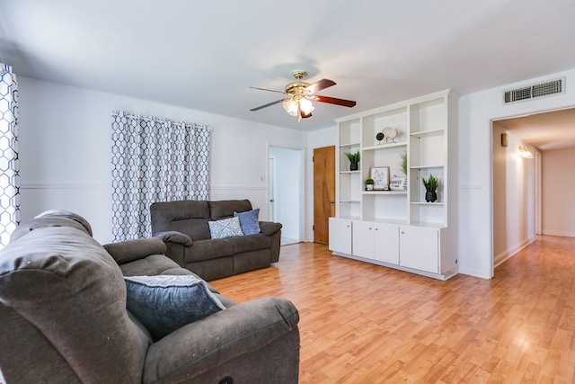 living room featuring ceiling fan and light wood-type flooring