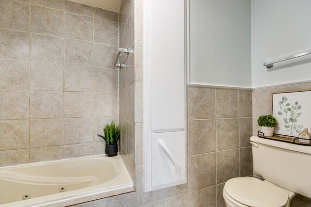 bathroom featuring tile walls, toilet, and separate shower and tub