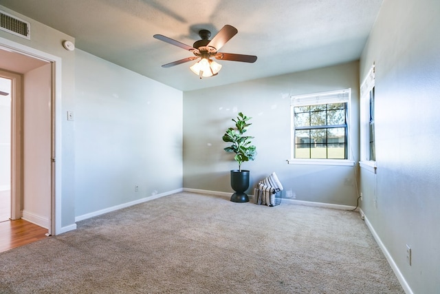 carpeted empty room featuring ceiling fan