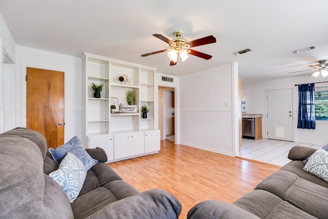 living room with ceiling fan and light hardwood / wood-style floors